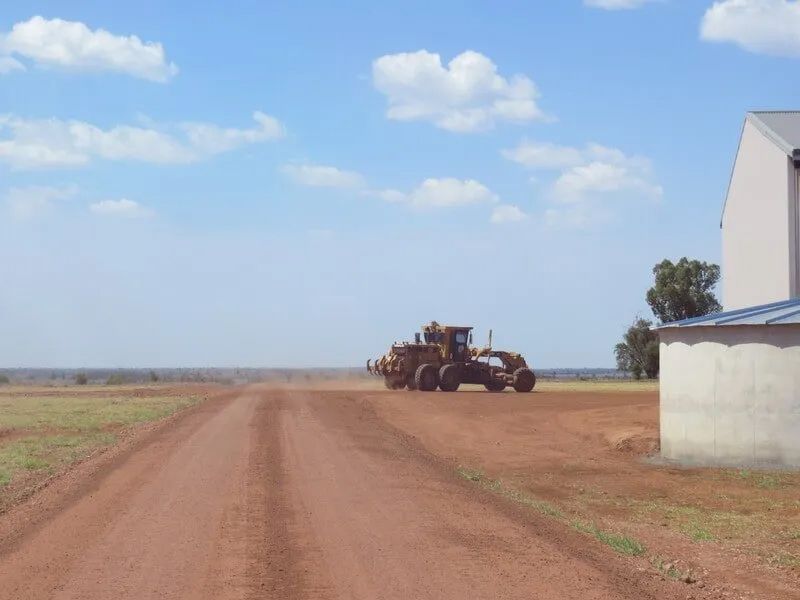 Rough Road Site With Excavator Running Over It — Mike Barlow Earthmoving Pty Ltd in Rockhampton, QLD