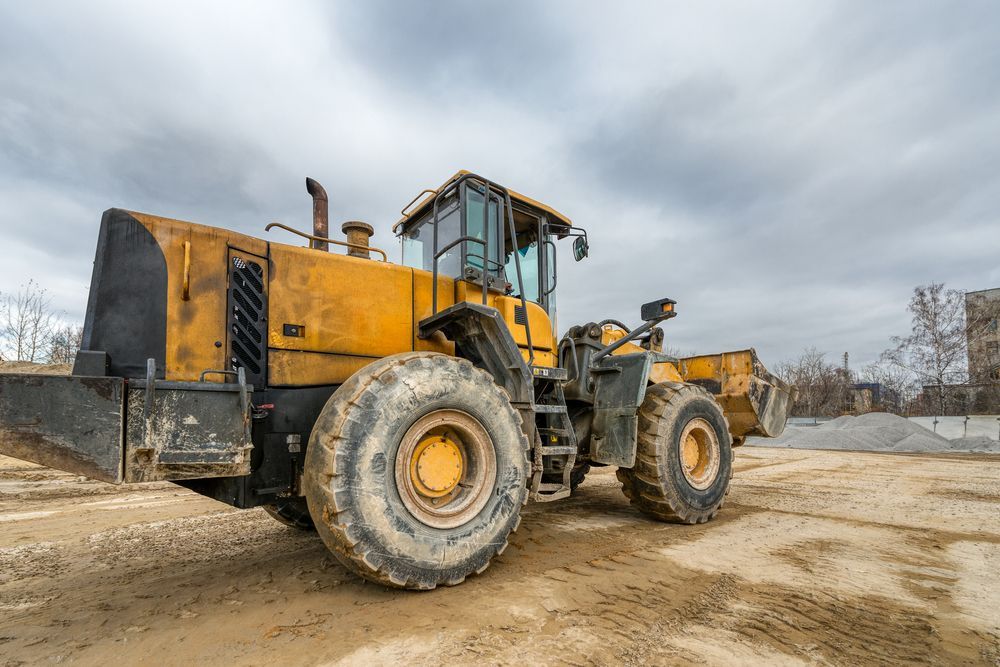 An Excavator On The Dirt Field