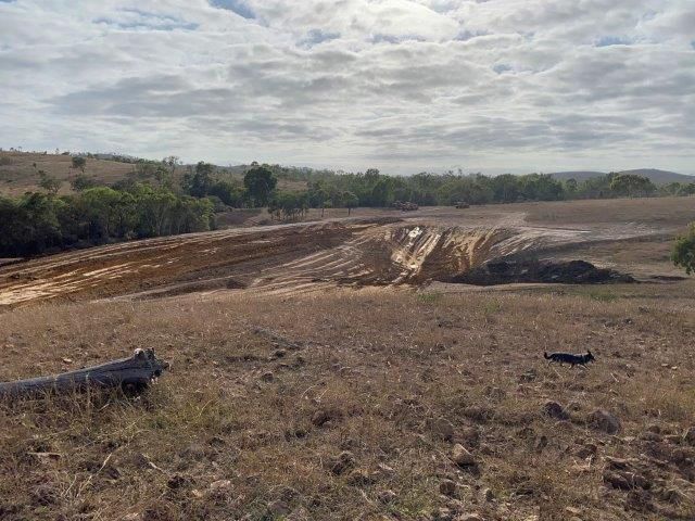 Field Site Construction With Two Yellow Big Excavators In The Dirt Field — Mike Barlow Earthmoving Pty Ltd in Rockhampton, QLD