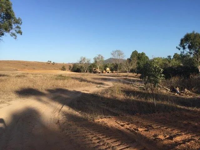 Landscape Construction Site With Two Yellow Big Excavators On The Dirt Field — Mike Barlow Earthmoving Pty Ltd in Rockhampton, QLD