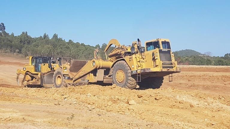 Two Yellow Big Excavators Are Working On The Site — Mike Barlow Earthmoving Pty Ltd in Rockhampton, QLD