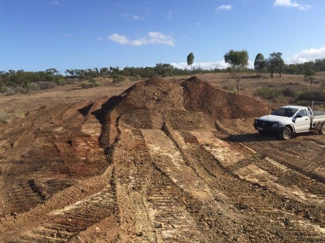 White Pick Up Driving In The Dirt Field — Mike Barlow Earthmoving Pty Ltd in Rockhampton, QLD