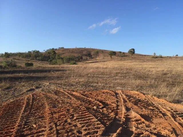 Landscape Of Two Yellow Big Excavators In The Dirt Field — Mike Barlow Earthmoving Pty Ltd in Rockhampton, QLD