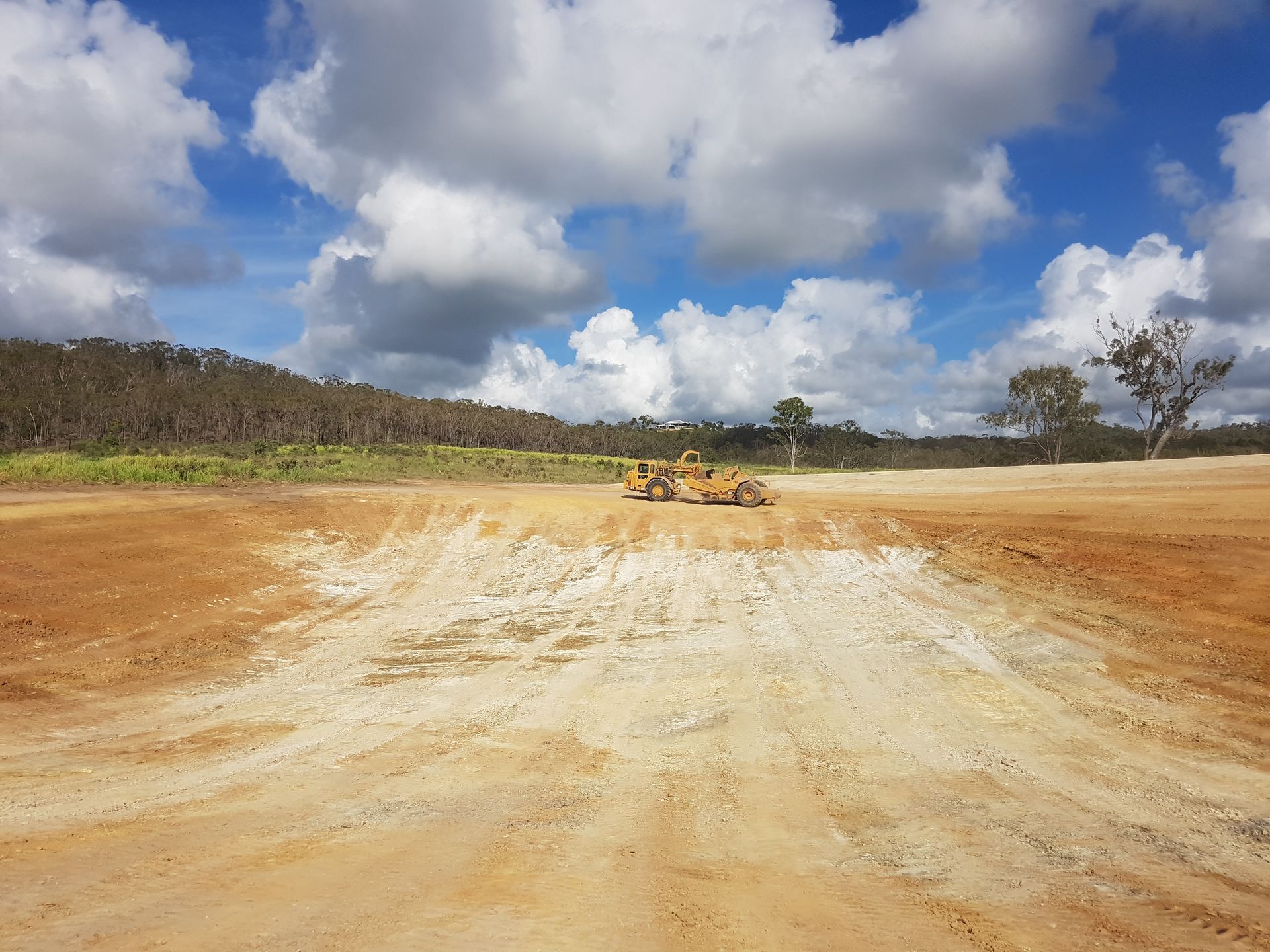 Yellow And Black Backhoe Working On Land Clearing