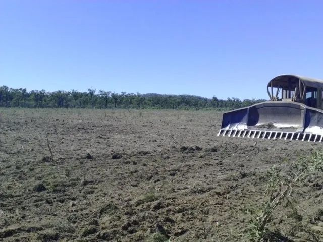 Land With Equipment Excavator Big Excavator In The Dirty Field — Mike Barlow Earthmoving Pty Ltd in Rockhampton, QLD