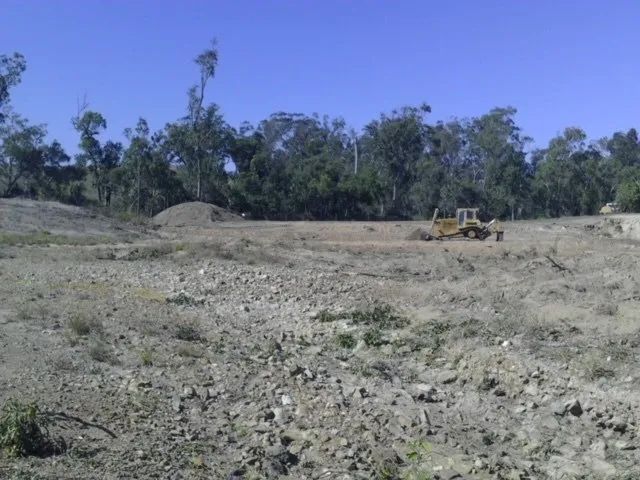 Dam Site Land Two Yellow Big Excavator In The Dirty Field — Mike Barlow Earthmoving Pty Ltd in Rockhampton, QLD