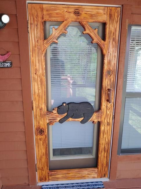Door has bear lying on a log