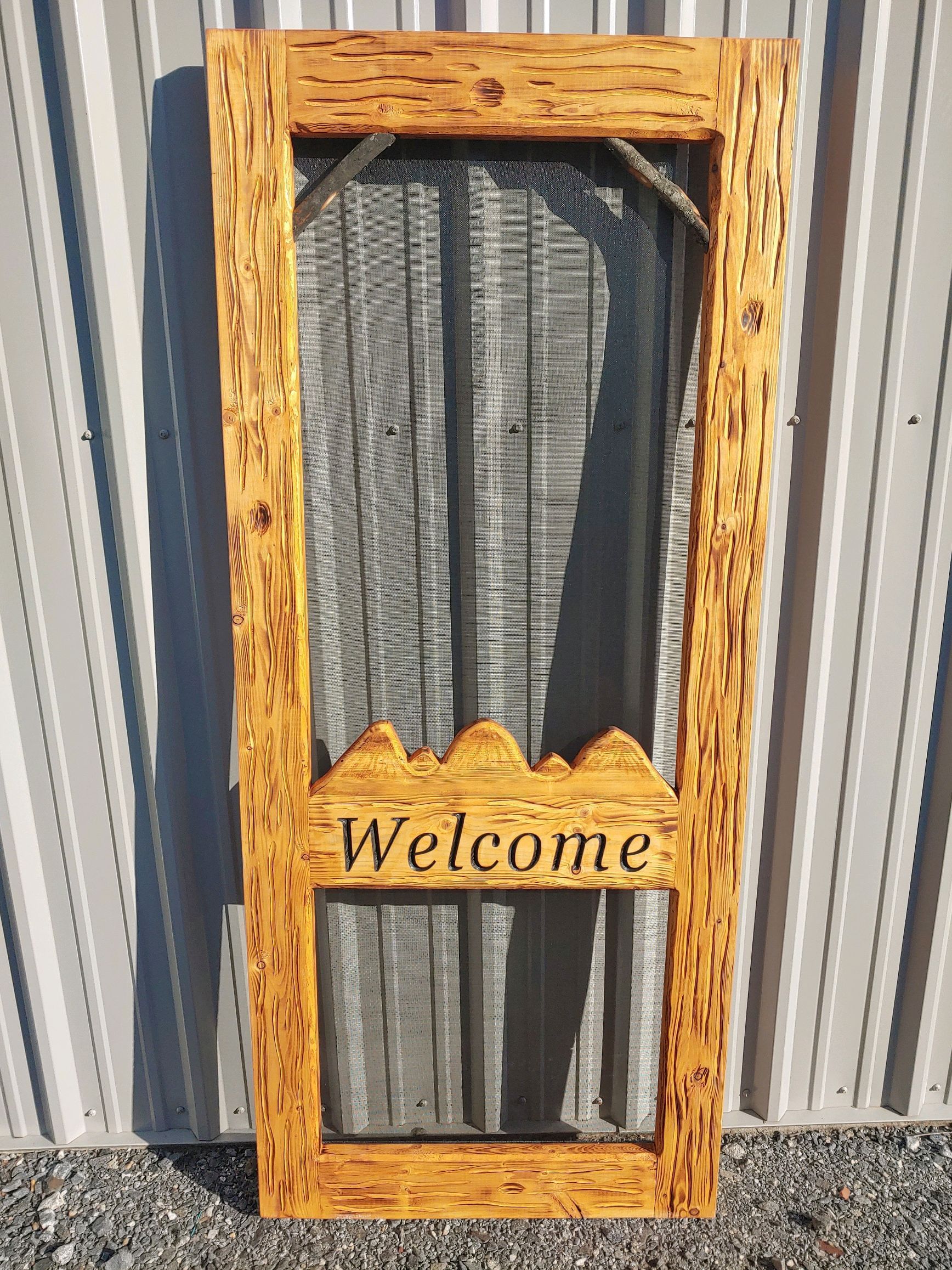 Rustic Screen Door with a Middle Rail shaped like a mountain range and carved with 