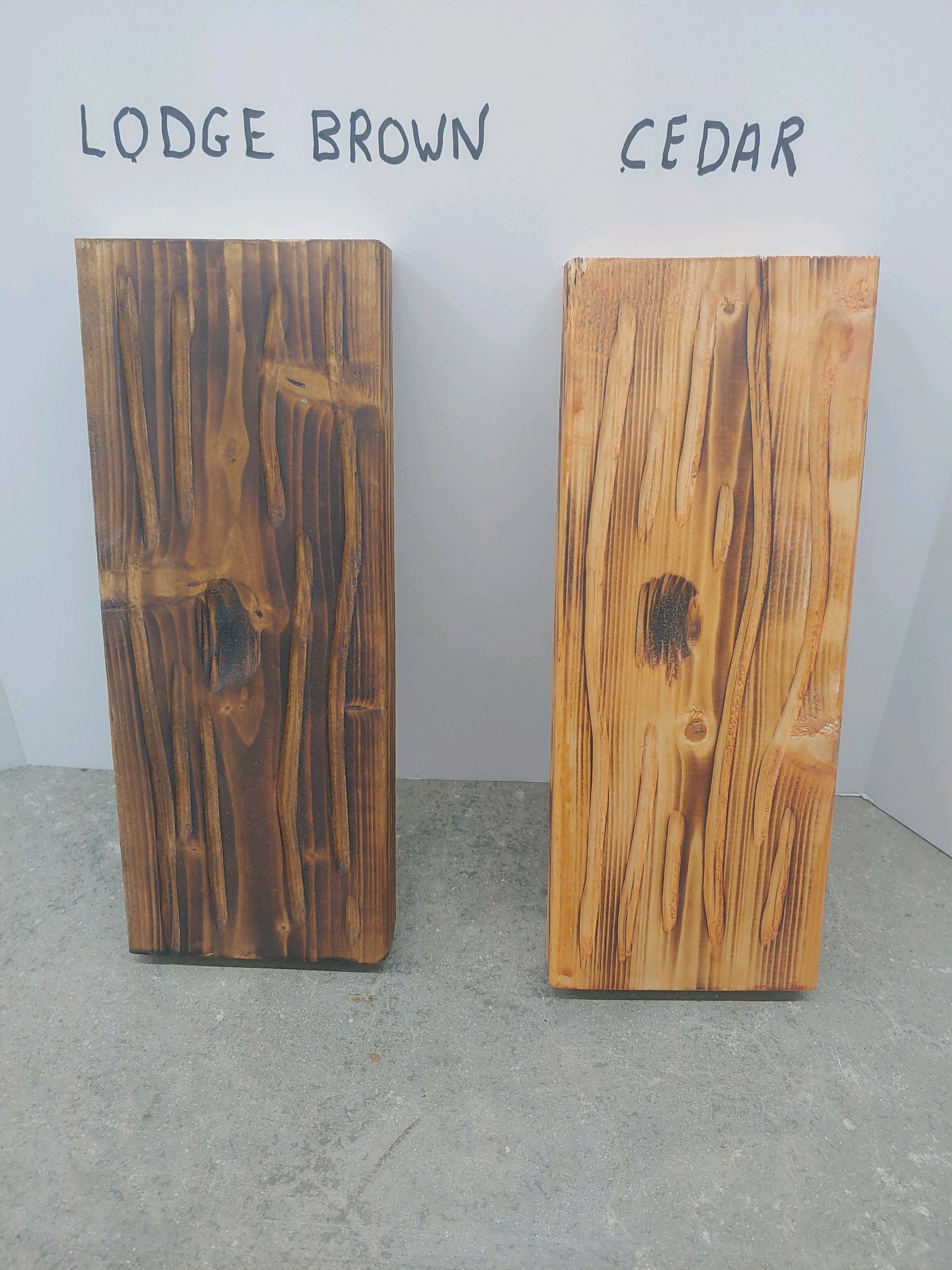 Two pieces of wood are sitting next to each other demonstrating available stain colors.