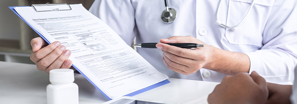A doctor is holding a clipboard and talking to a patient. A doctor is holding a clipboard and talking to a patient.
