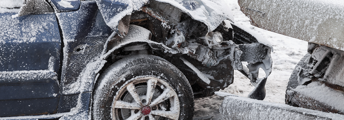 A car has been damaged in a snowy accident. A car has been damaged in a snowy accident.