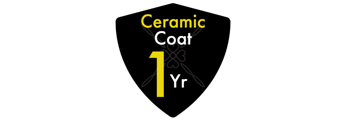 A black shield with the words ceramic coat 1 yr on it
