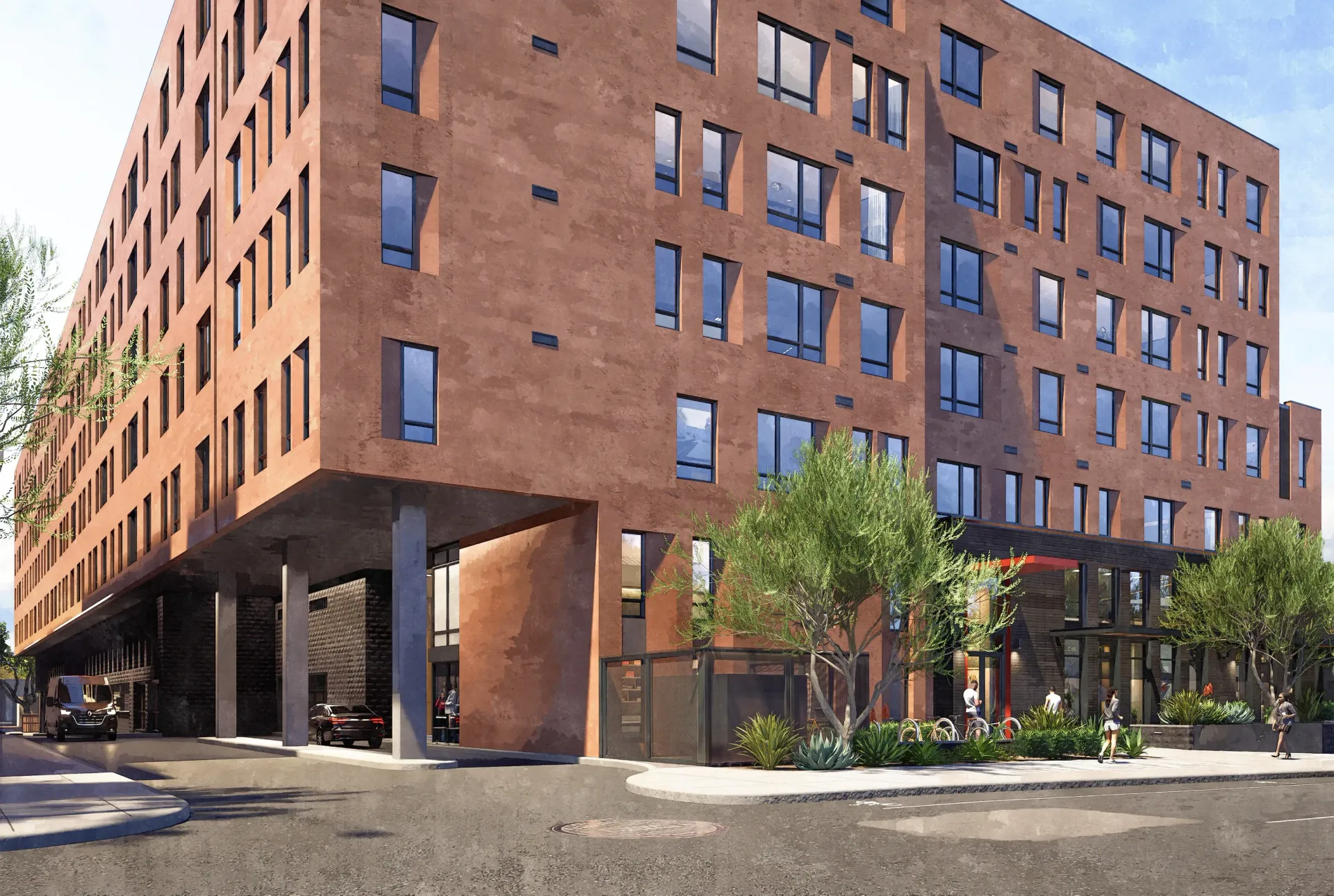 Exterior view of a modern apartment building with a terracotta facade and large windows.