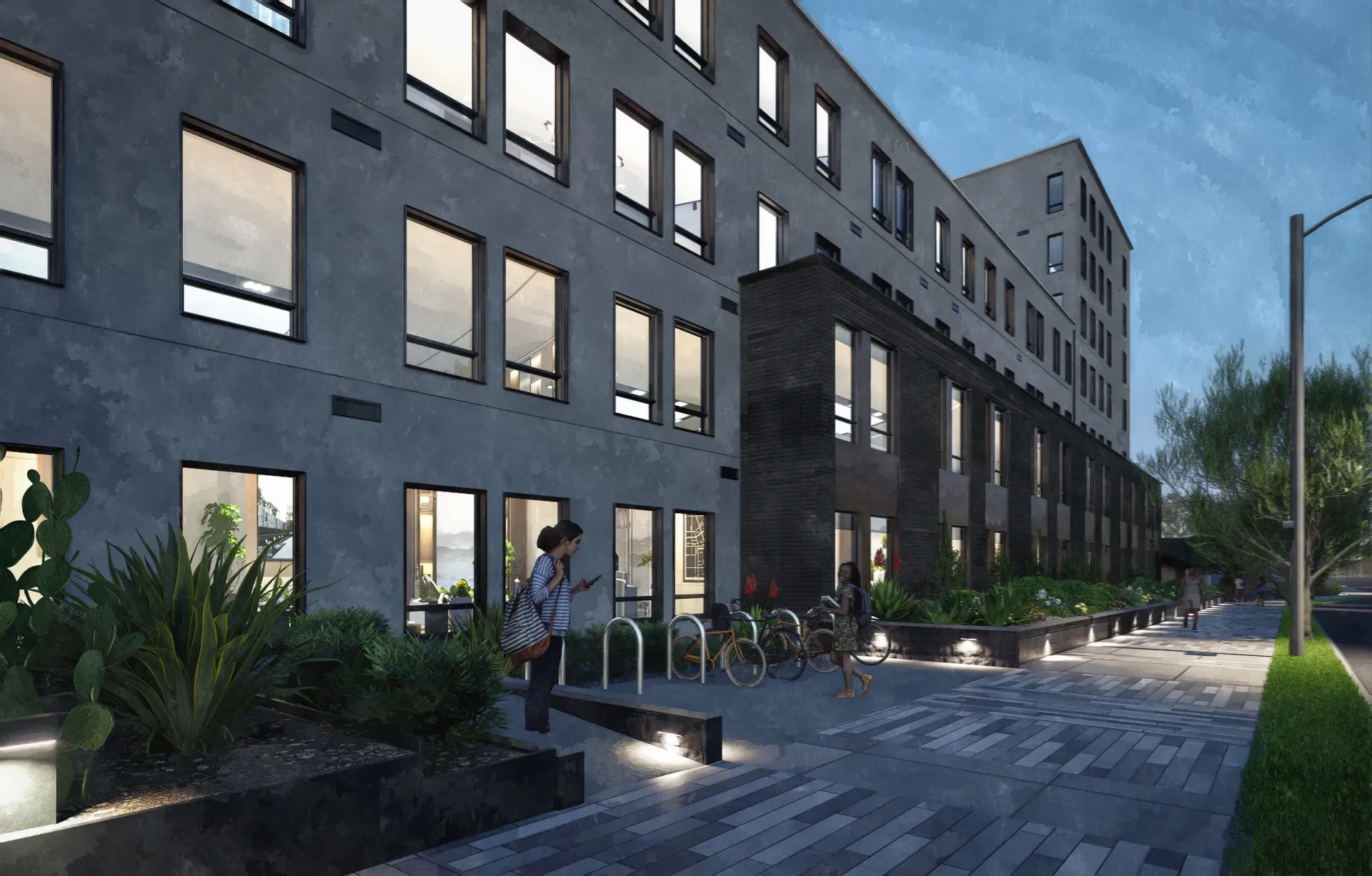 Modern apartment building exterior with people walking and biking in front.