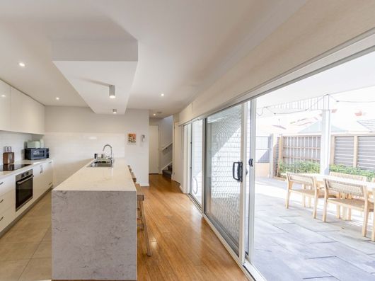 Modern open-plan kitchen and living area at Avoca Place Geelong