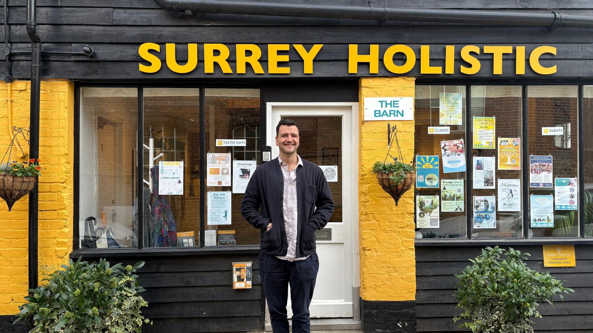 A picture of Josh, the acupuncturist, standing in front of the Surrey Holistic Centre based in Godalming.