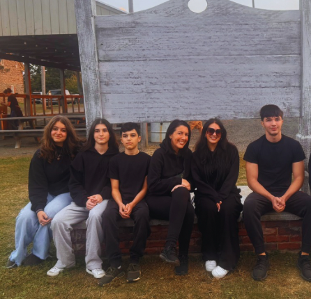 A group of people standing in front of a window with a ghost on it