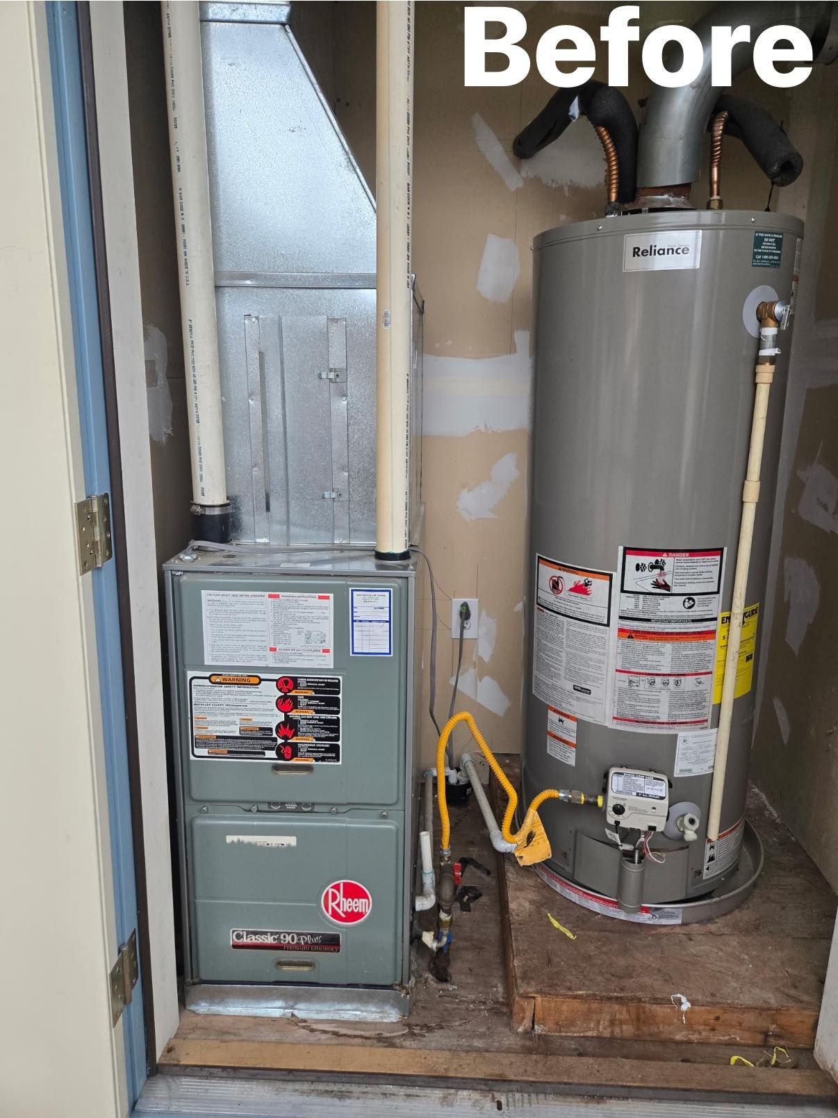 A utility closet containing a Rheem furnace unit on the left and a tall cylindrical water heater on the right.
