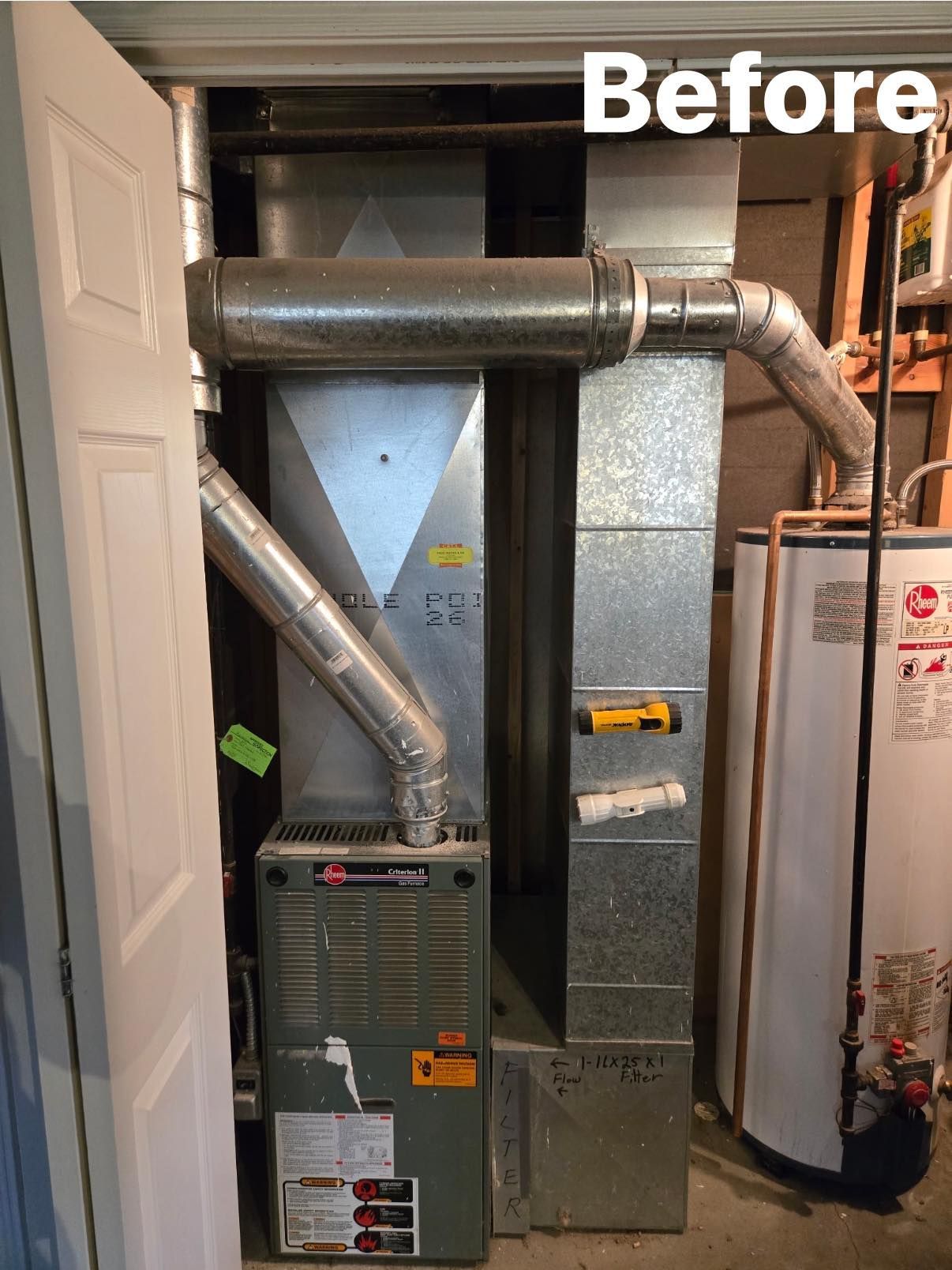 A furnace and metal ductwork located in a small closet next to a water heater, labeled 