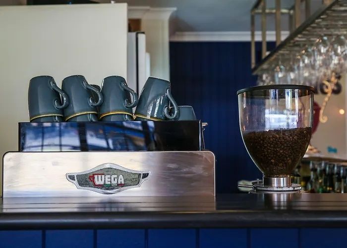 Coffee machine with Wega logo and a cup of espresso on a bar counter