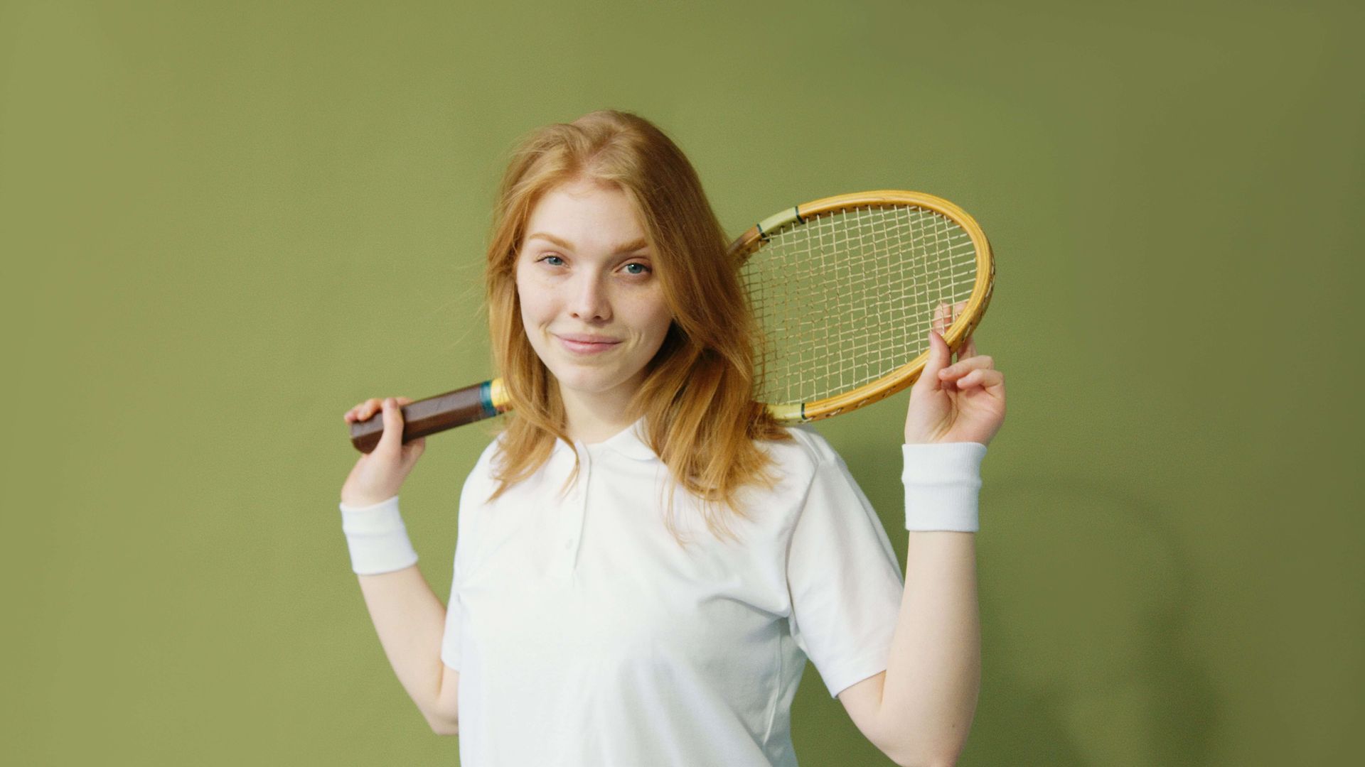 Happy athlete smiling while holding a squash racket, symbolizing confidence, resilience, and renewed enjoyment of sports supported through sports performance anxiety therapy in Omaha, NE | sports performance anxiety therapy omaha ne - anxiety therapy omaha ne - anxiety therapist omaha ne - elkhorn - gretna - bennington - blair - millard - wahoo - waverly - papillion