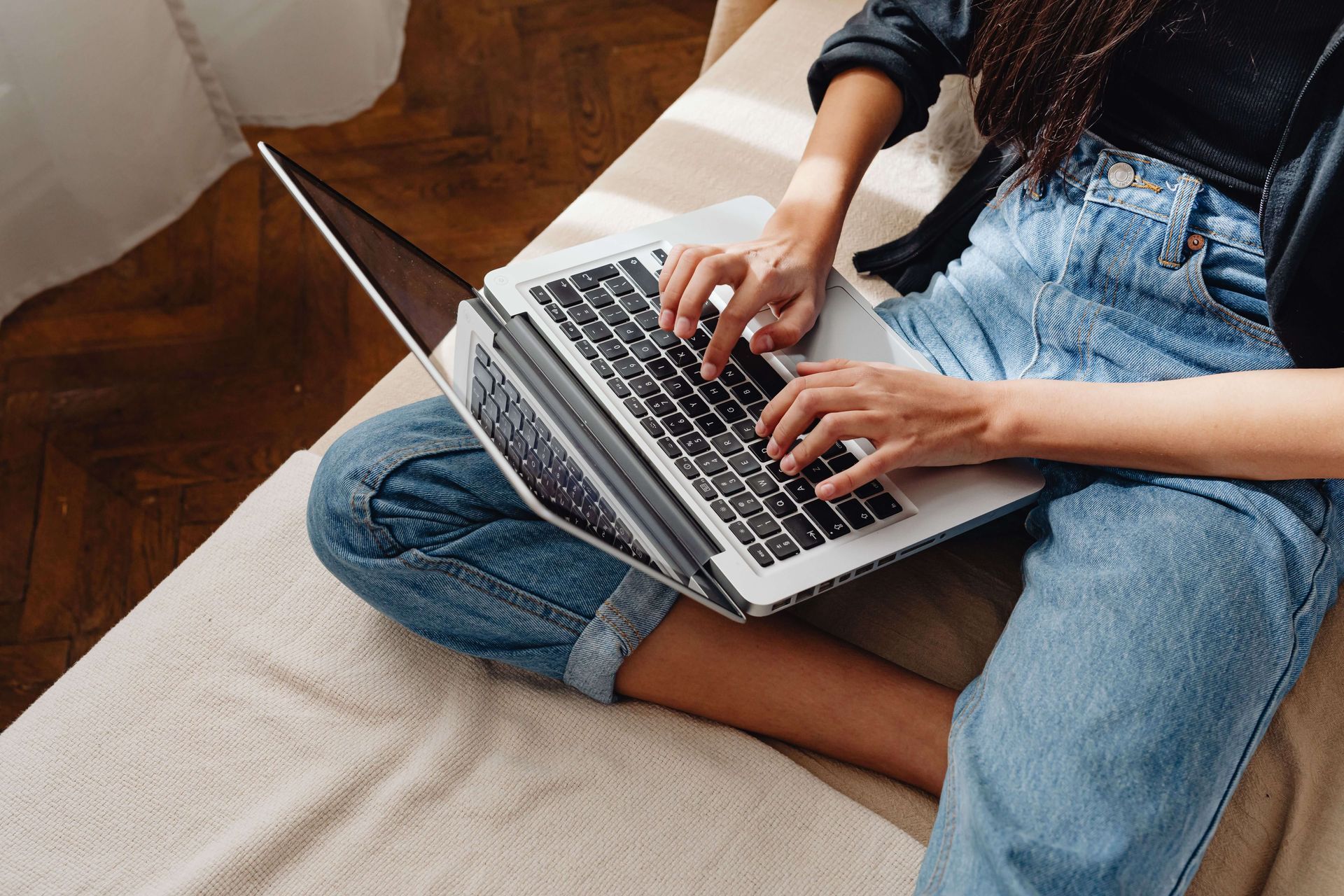 Person using a laptop, representing convenient and accessible online anxiety therapy in Omaha, NE.