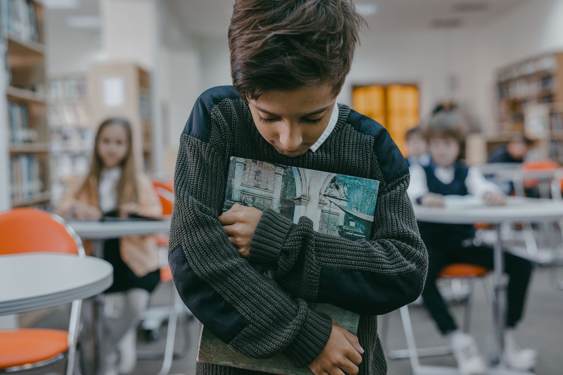 Sad, shy student at school, reflecting emotional struggles that may be addressed through anxiety and depression in Omaha, NE | anxiety in sports omaha ne - anxiety and athletes omaha ne - anxiety therapy omaha ne - elkhorn - gretna - bennington - blair - millard - wahoo - waverly - papillion