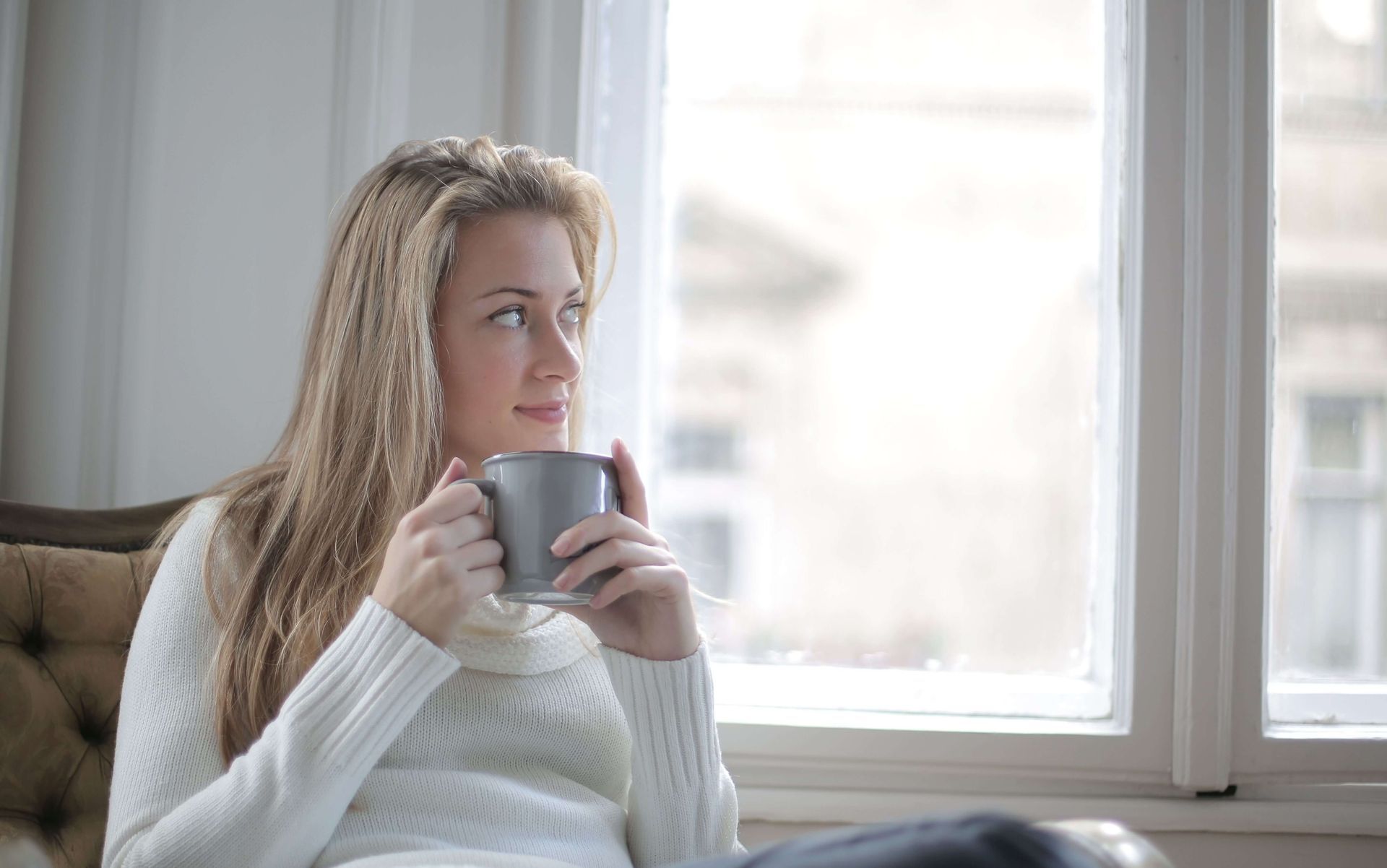 Woman holding a coffee mug and appearing calm, symbolizing relaxation, coping skills, and emotional regulation supported through anxiety therapy in Omaha, NE | anxiety therapy omaha ne - anxiety counseling omaha ne - anxiety therapist omaha ne - elkhorn - gretna - bennington - blair - millard - wahoo - waverly - papillion