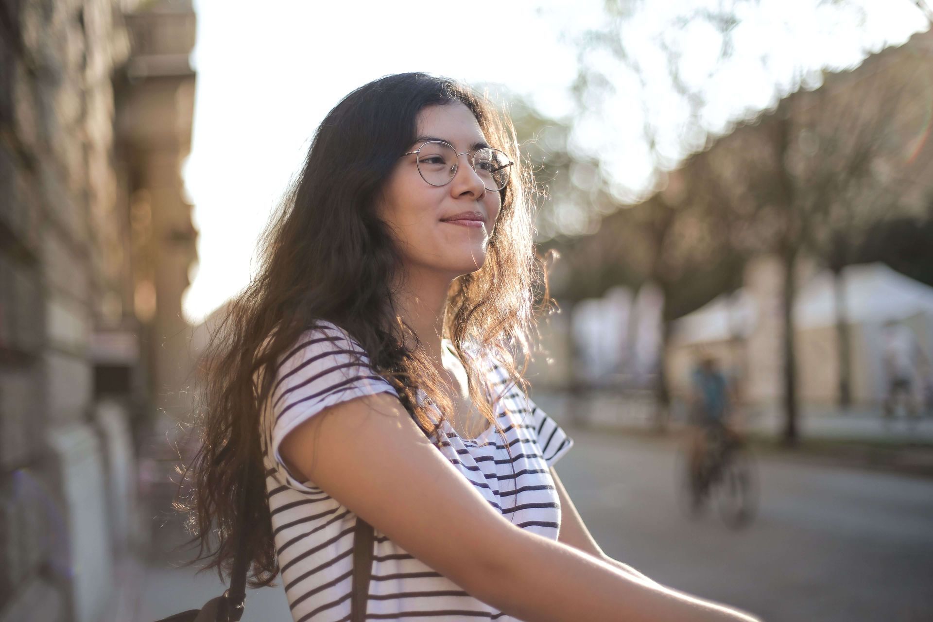 Happy person smiling outdoors, symbolizing improved well-being and greater confidence supported through online anxiety therapy in Omaha, NE | online anxiety therapy omaha ne - anxiety therapy omaha ne - anxiety therapist omaha ne - elkhorn - gretna - bennington - blair - millard - wahoo - waverly - papillion
