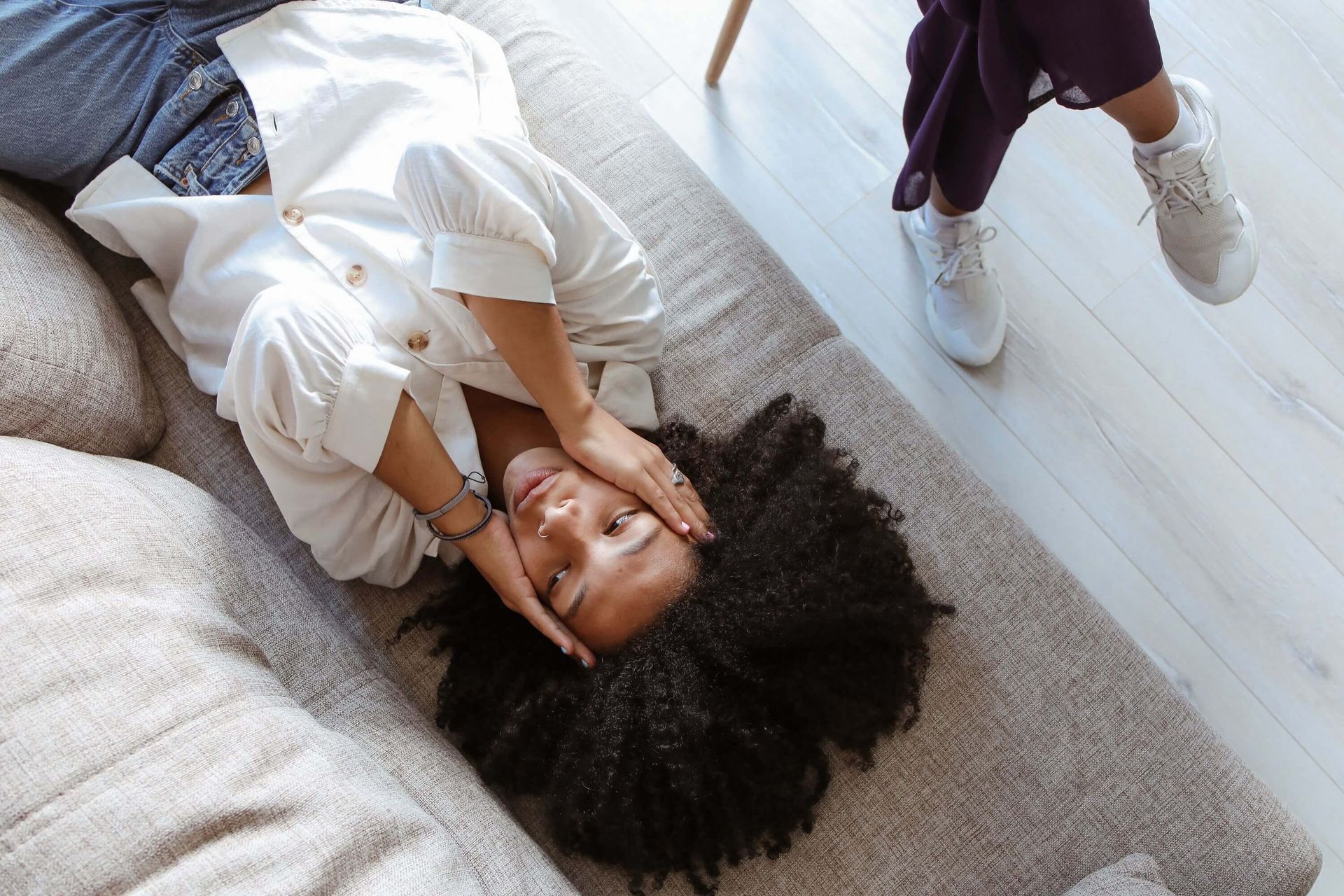 Woman lying on a couch during a therapy session. Therapy for social anxiety in Omaha, NE, can help.