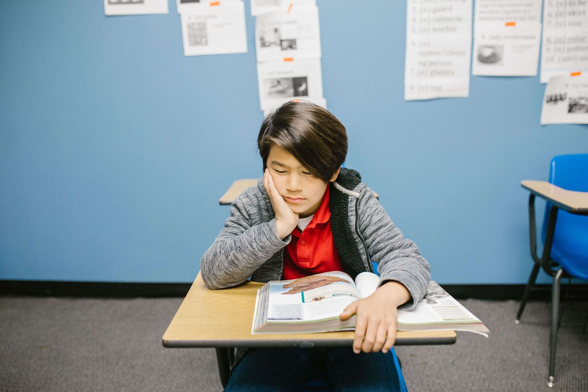 Stressed child at school, reflecting anxiety that may be addressed through anxiety therapy in Omaha.
