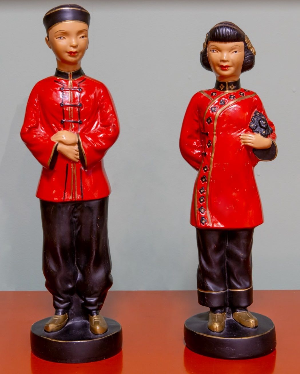 A man and a woman are standing next to each other on a table
