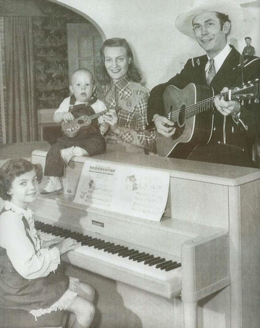 A black and white photo of a family playing instruments
