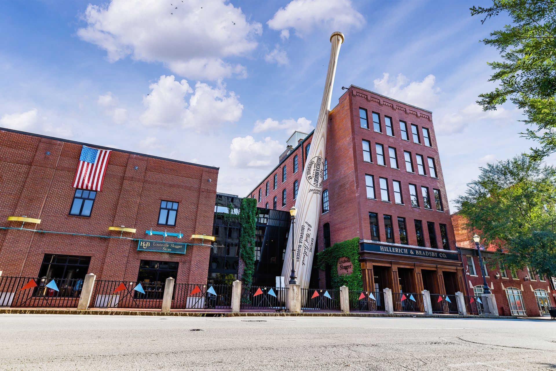 A large brick building with an american flag on the side of it.