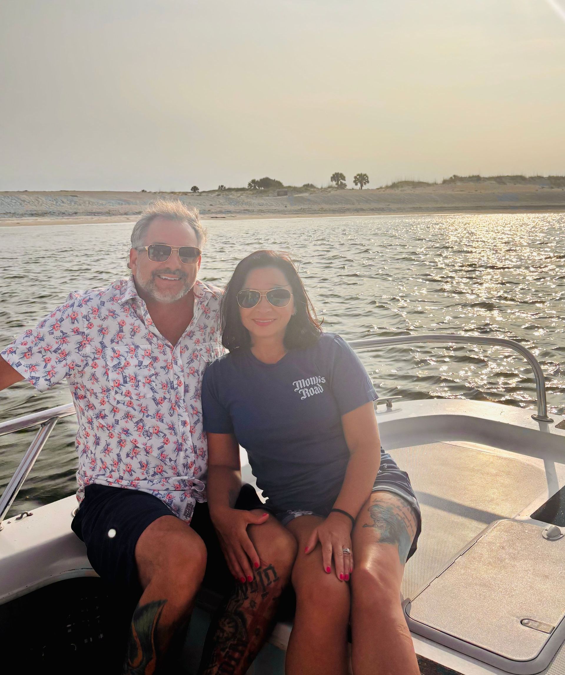 A man and a woman are sitting on a boat in the water