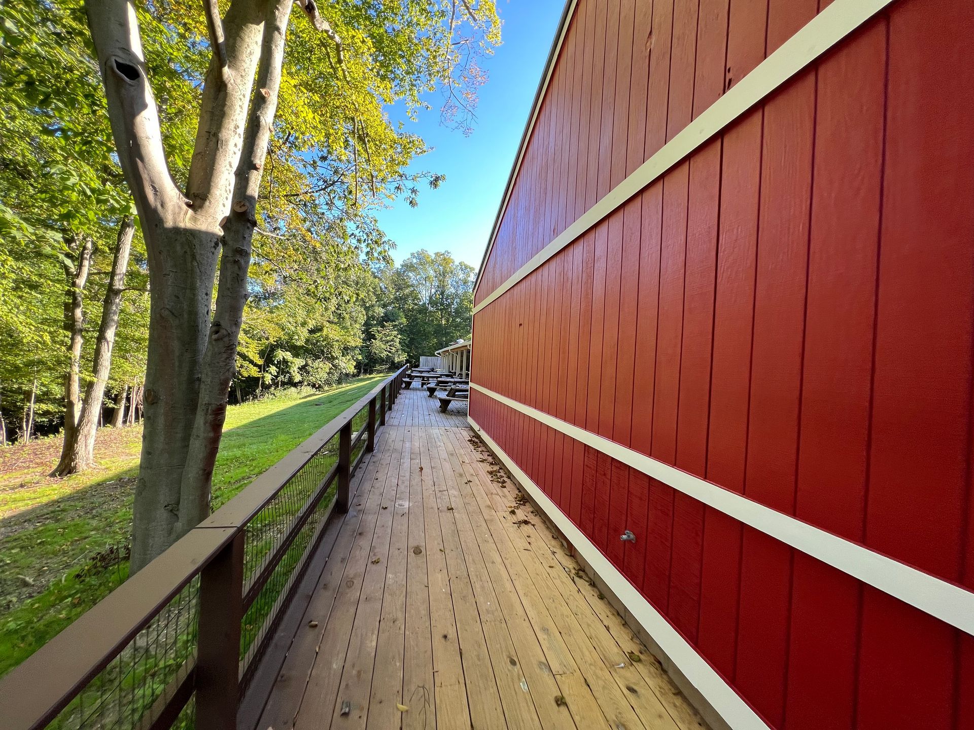 a wooden walkway leading to a red building