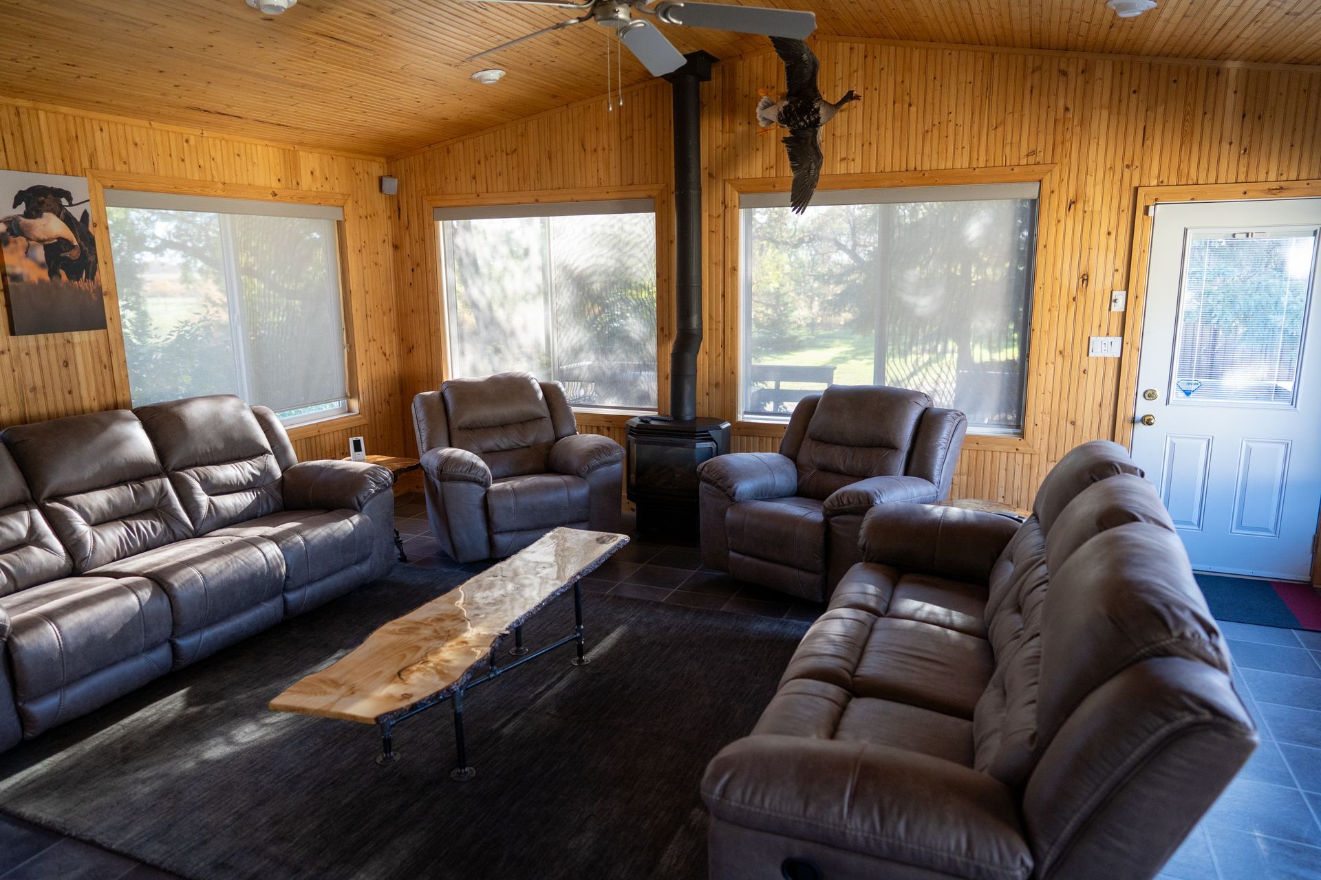 A living room filled with furniture and a ceiling fan.