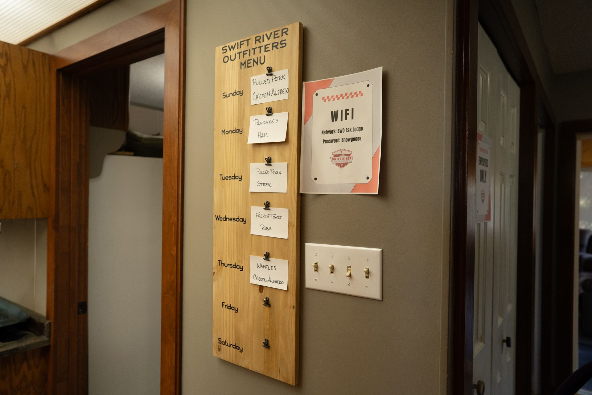 A wooden board with a list of things to do on it is hanging on a wall.