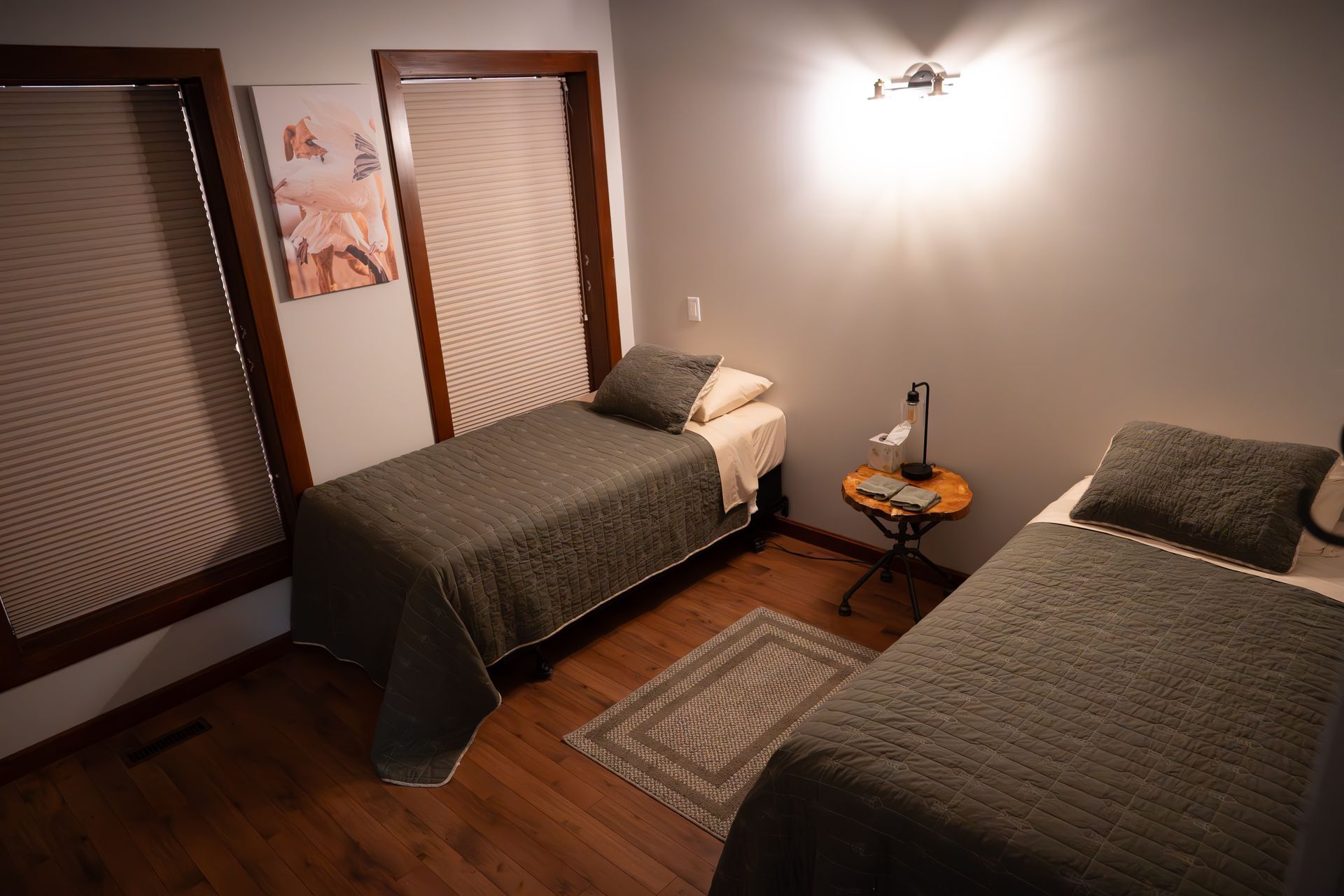 A bedroom with two twin beds and a nightstand.