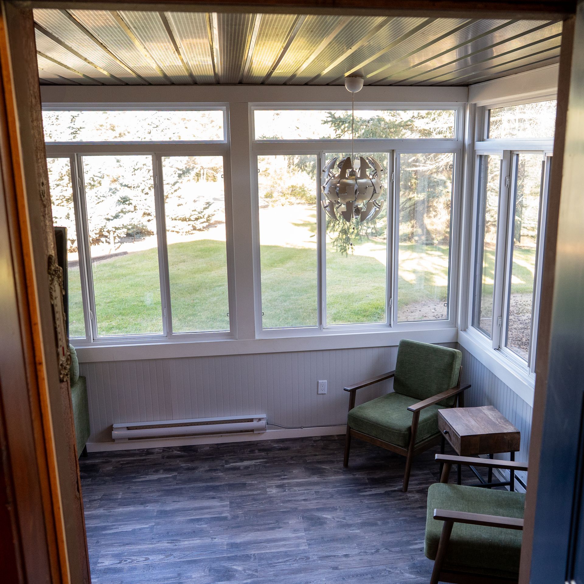 A room with a lot of windows and chairs