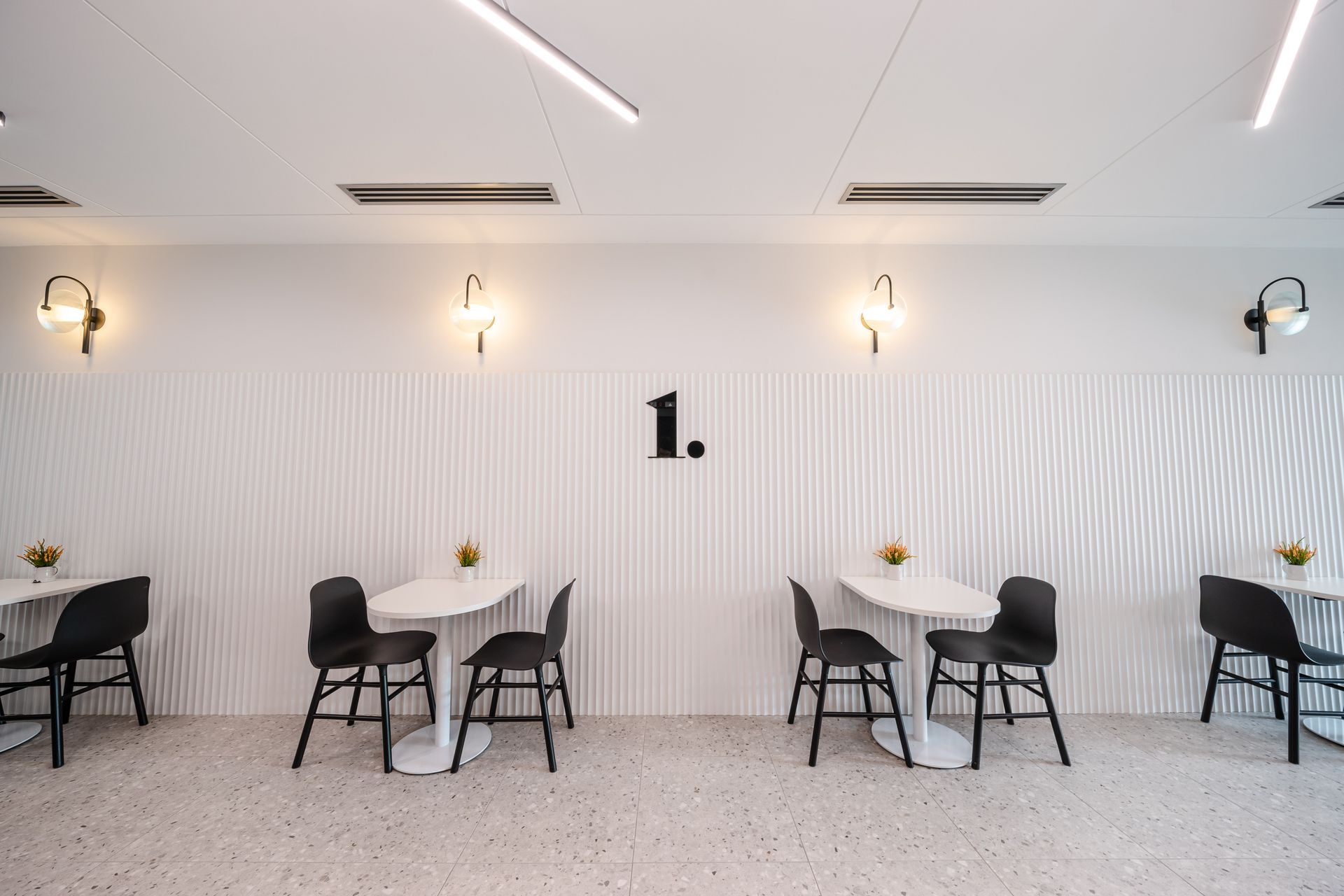 A Row Of Tables And Chairs In A Room With A White Wall – Brendale, QLD - DB Electrical