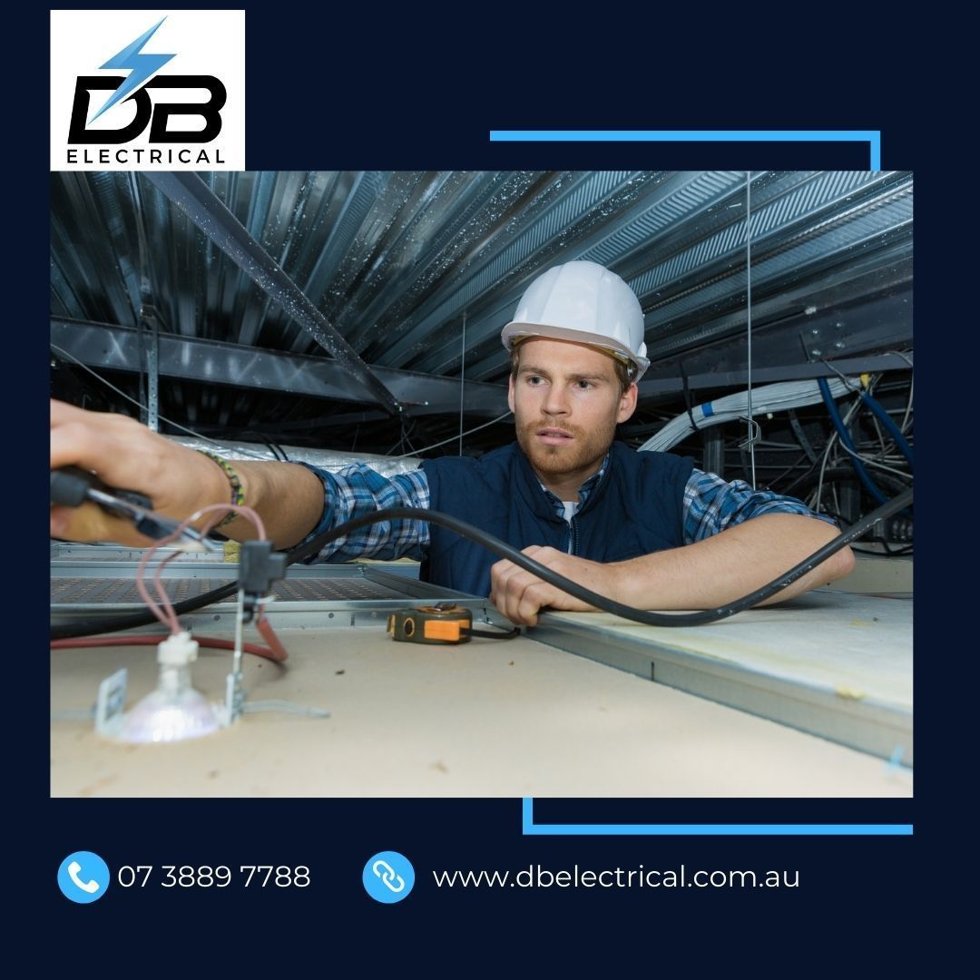 A Man In A Hard Hat Is Working On Electrical Wires – Brendale, QLD - DB Electrical