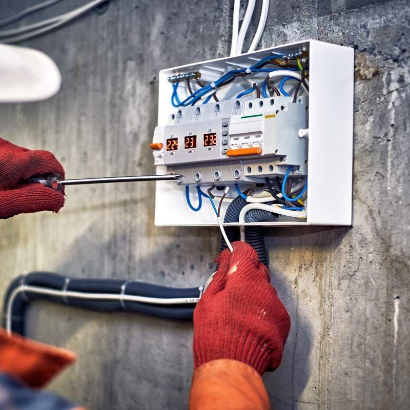 A Person Is Working On An Electrical Box With A Screwdriver – Brendale, QLD - DB Electrical