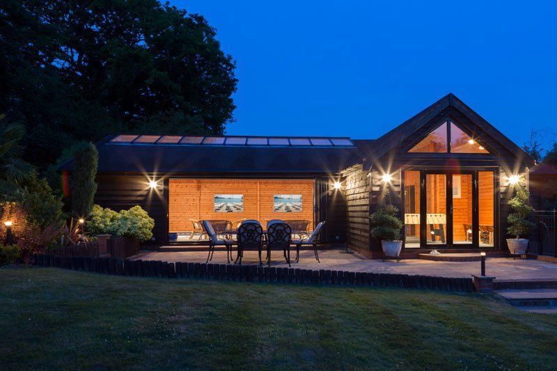 A House With A Patio And Chairs In Front Of It At Night – Brendale, QLD - DB Electrical