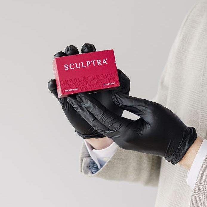 Sculptra box being held by Rejuvn8 pracitioner