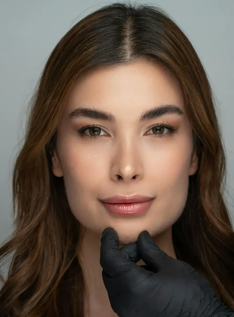 A female patient who is having her facial features examined prior to dermal filler.