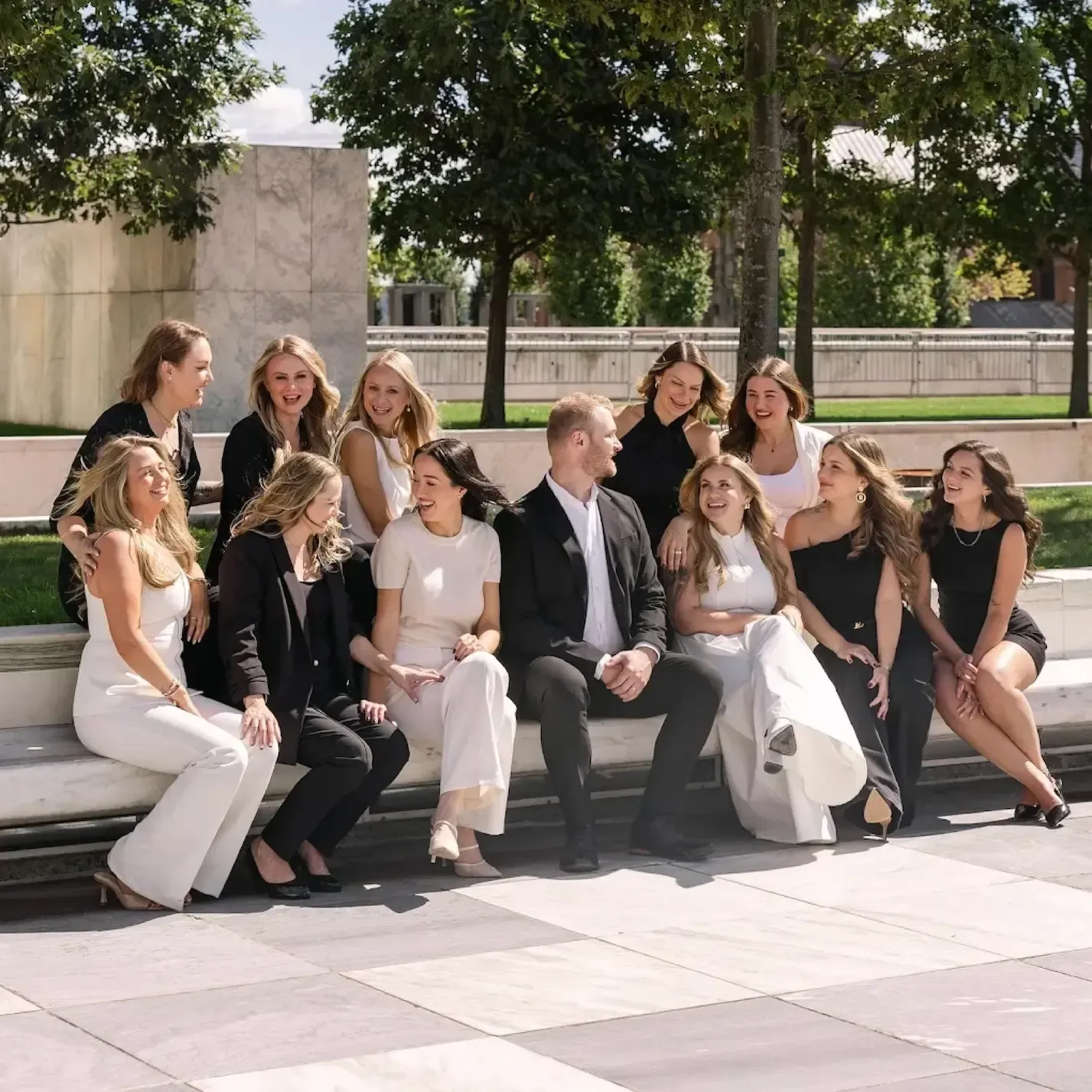 The Rejuvn8 team sitting on steps in Rochester, NY