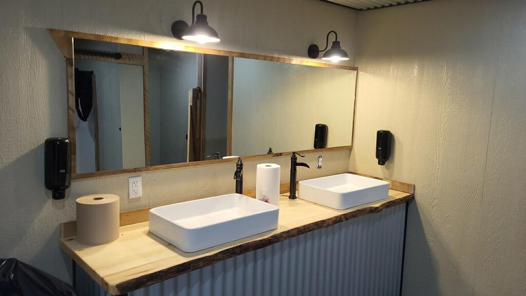 Two wall-mounted urinals in a clean restroom at Workforce RV Park in Rayville, MO