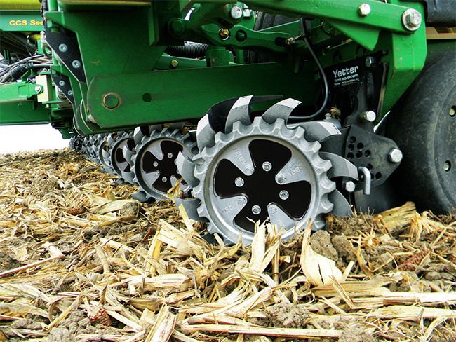 A close up of a tractor 's tracks in a field