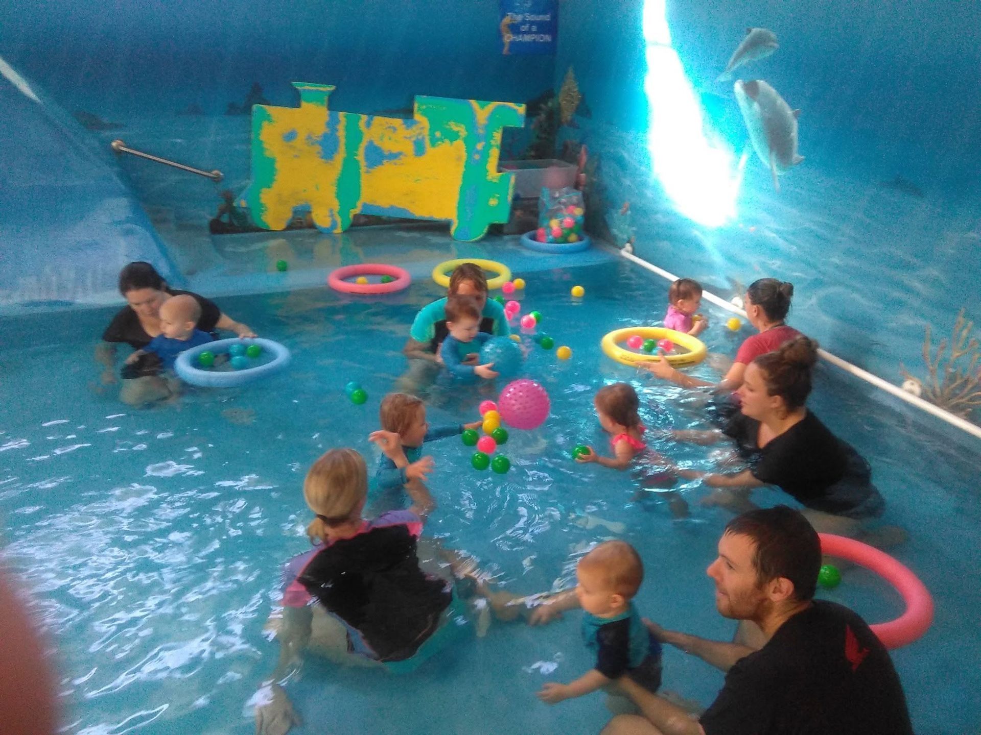 Children in a Blue Pool Wearing Float Rings — Swim Care Boambee in Coffs Harbour, NSW